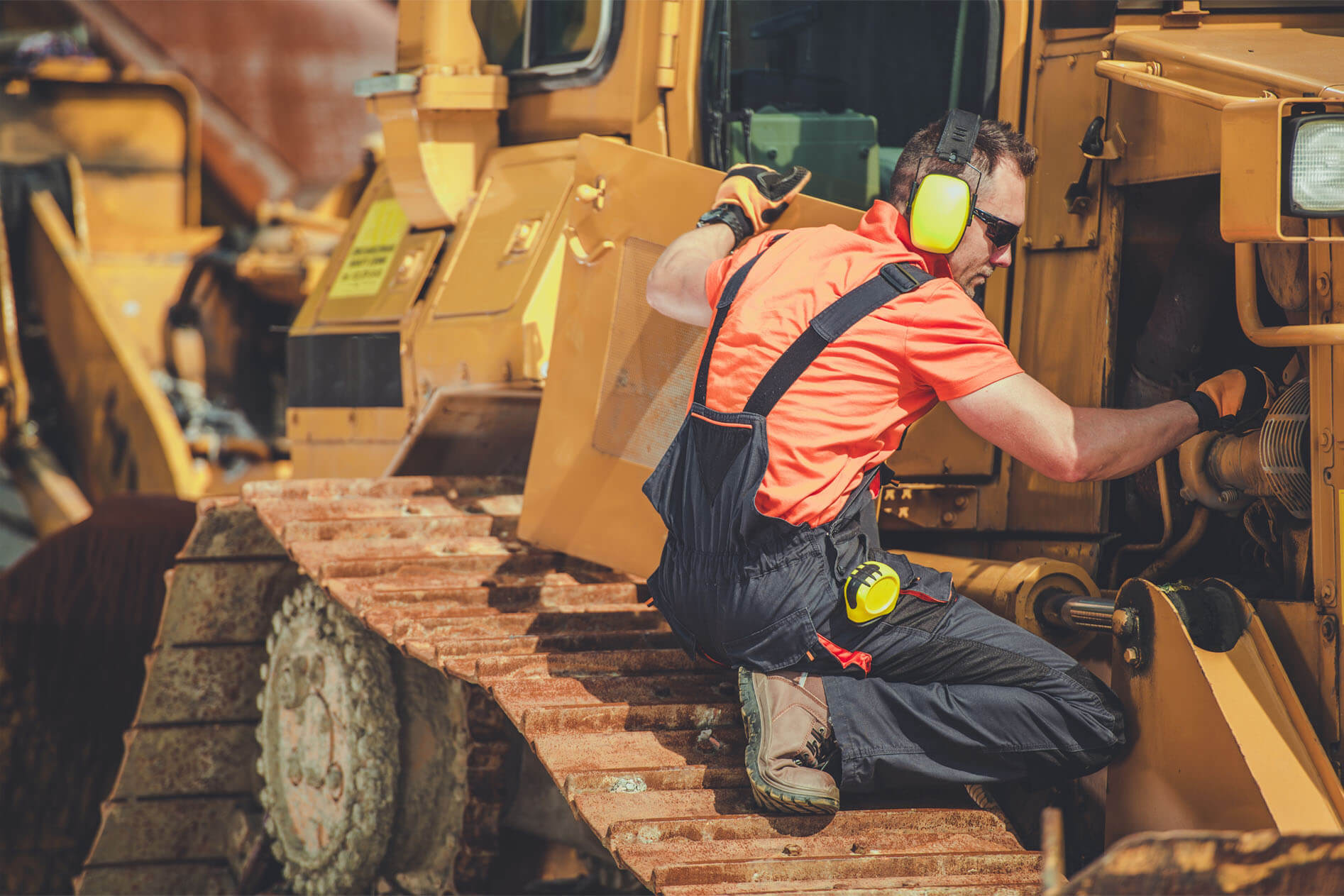Machanic works on a piece of construction equipment
